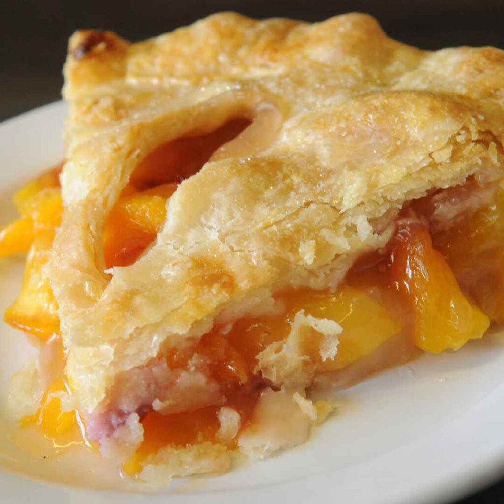 Enjoy a delicious homemade honey peach pie with a golden crust, sweetened naturally with honey. Perfect for a fresh, flavorful dessert!