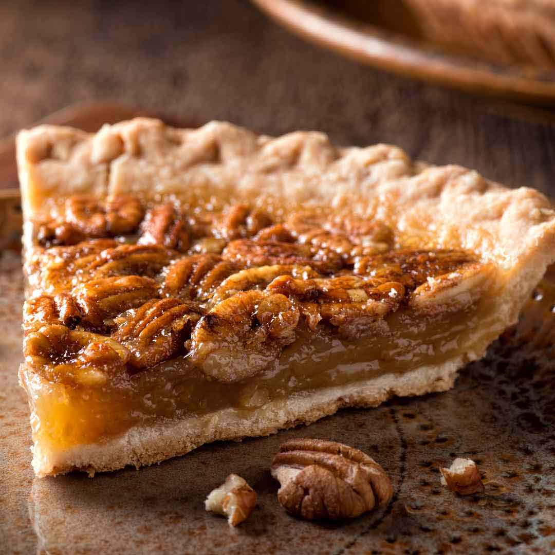 "A homemade honey pecan pie with a golden, flaky crust, freshly baked to perfection." "A delicious slice of pecan pie sweetened with natural honey, served on a plate." "Close-up of a freshly baked pecan pie featuring a glossy honey glaze." "A traditional Southern-style pecan pie made with pure honey, showcasing its rich filling." "A mouthwatering pecan dessert infused with honey, highlighting the crunchy pecans and smooth texture."